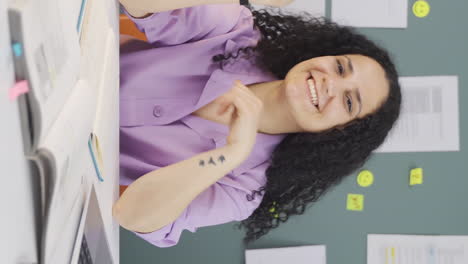 Vertical-video-of-Female-student-looking-at-camera-with-positive-and-positive-gesture.